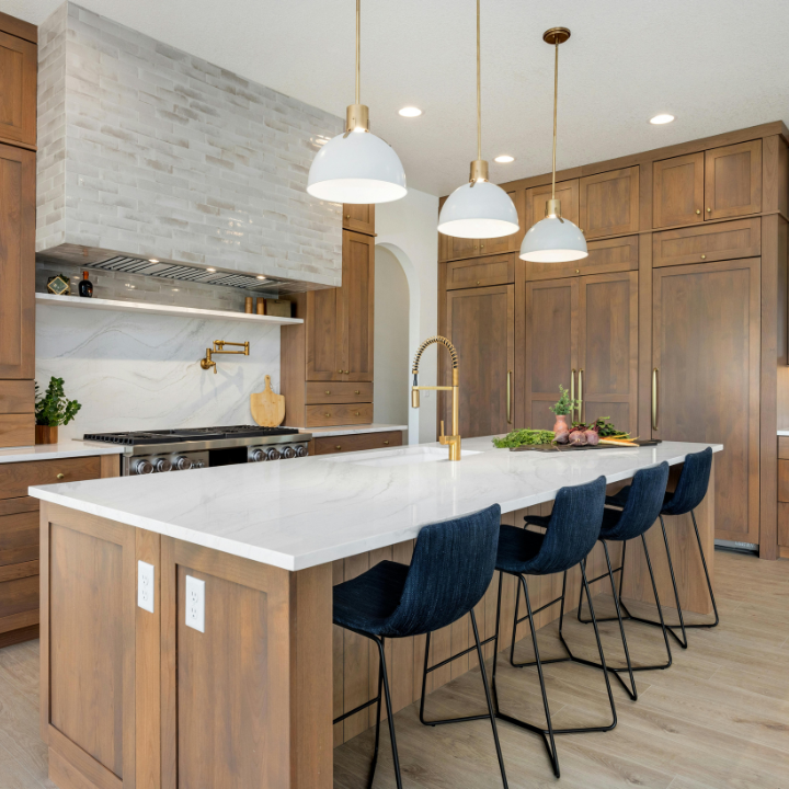 A bright, freshly cleaned kitchen with a spotless island and polished surfaces